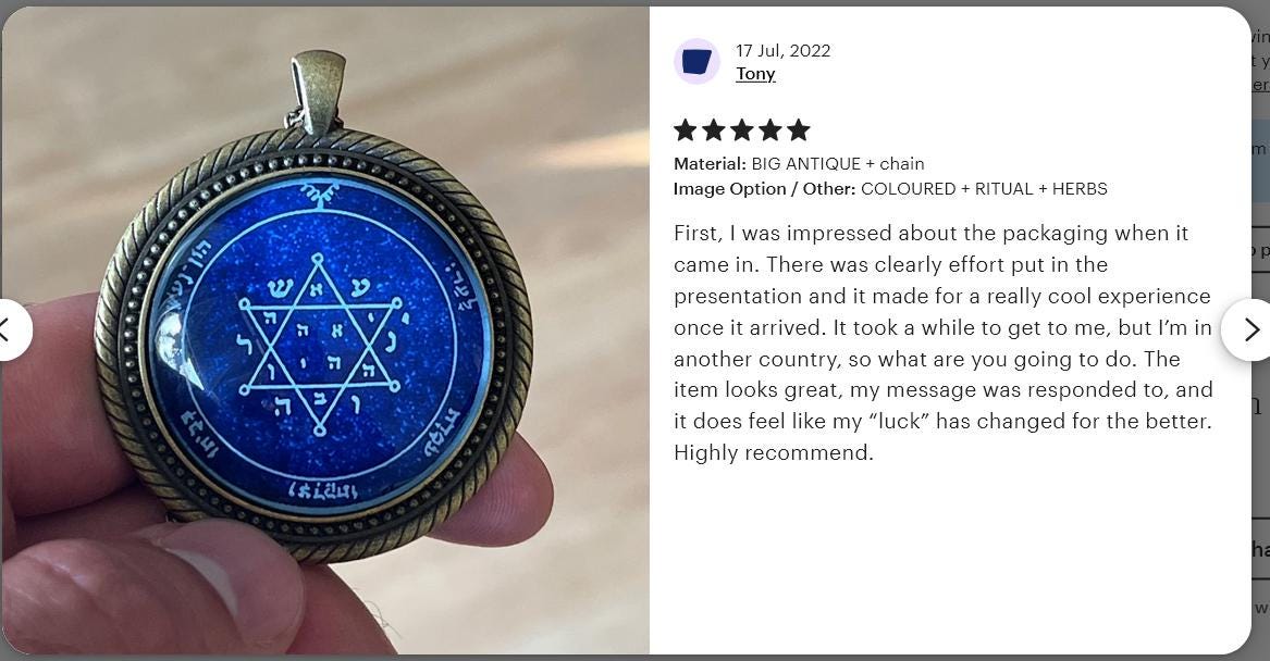 a person holding a pendant with a pentagramil on it