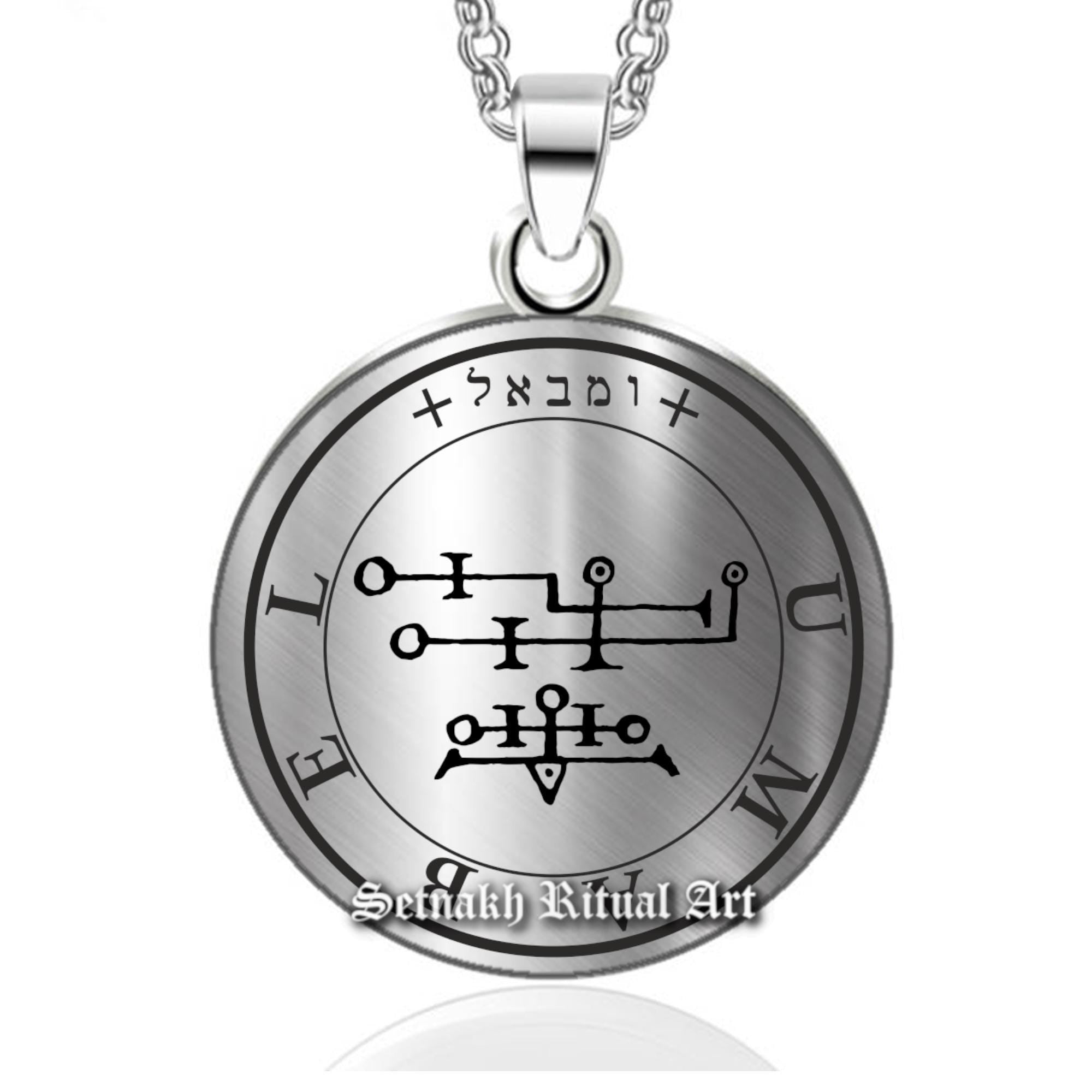 a silver pendant with a cross on it