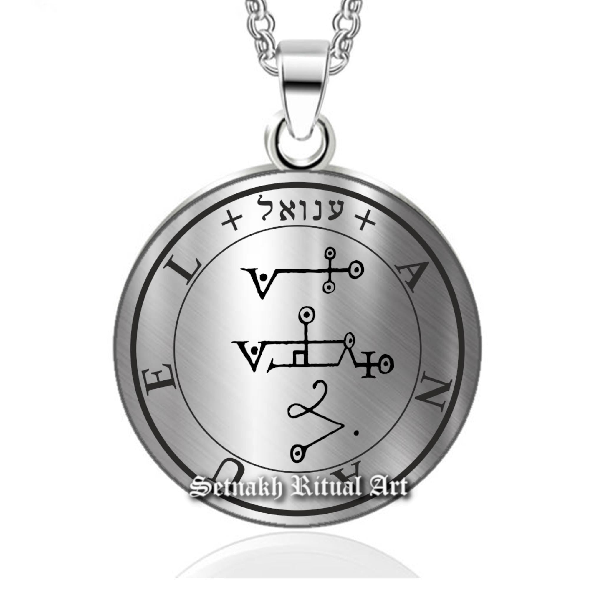 a silver pendant with the symbols of the four elements