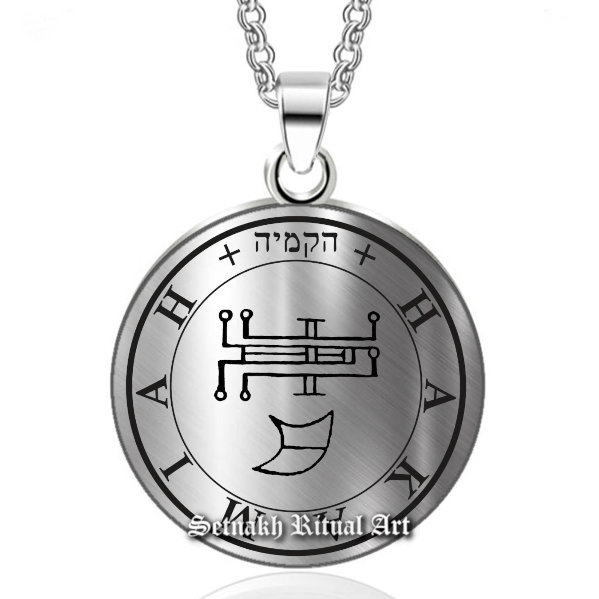 a silver necklace with an image of a wheel of fate on it