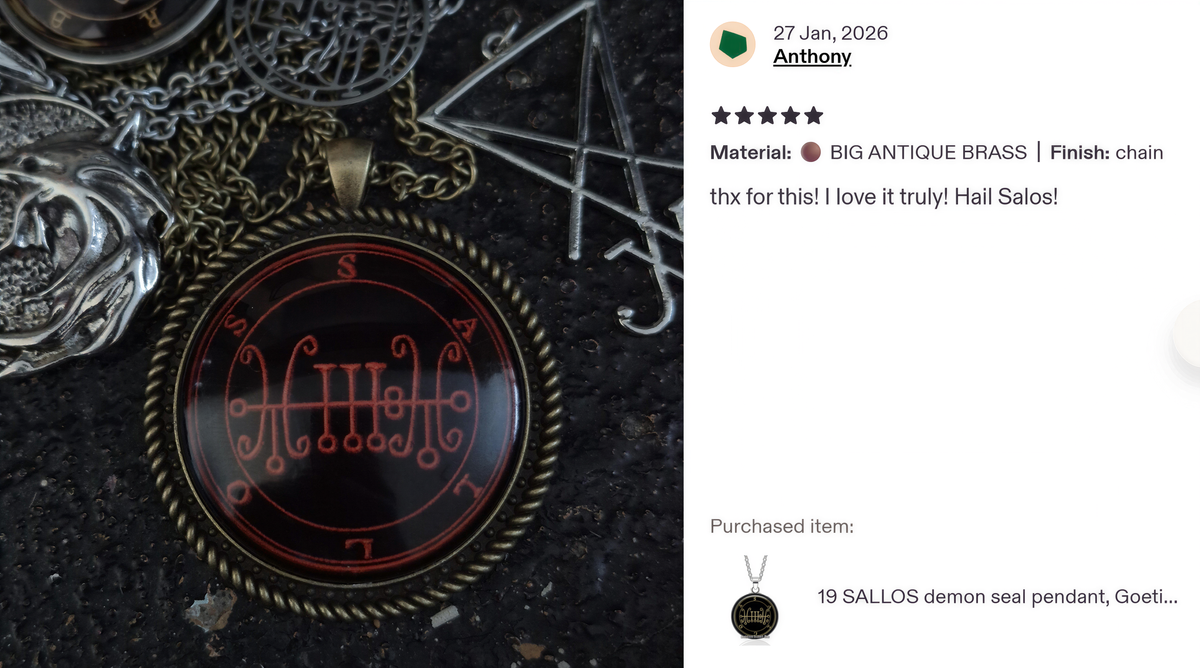 a close-up of a pendant with a red and black design, surrounded by various other pendants and jewelry pieces.