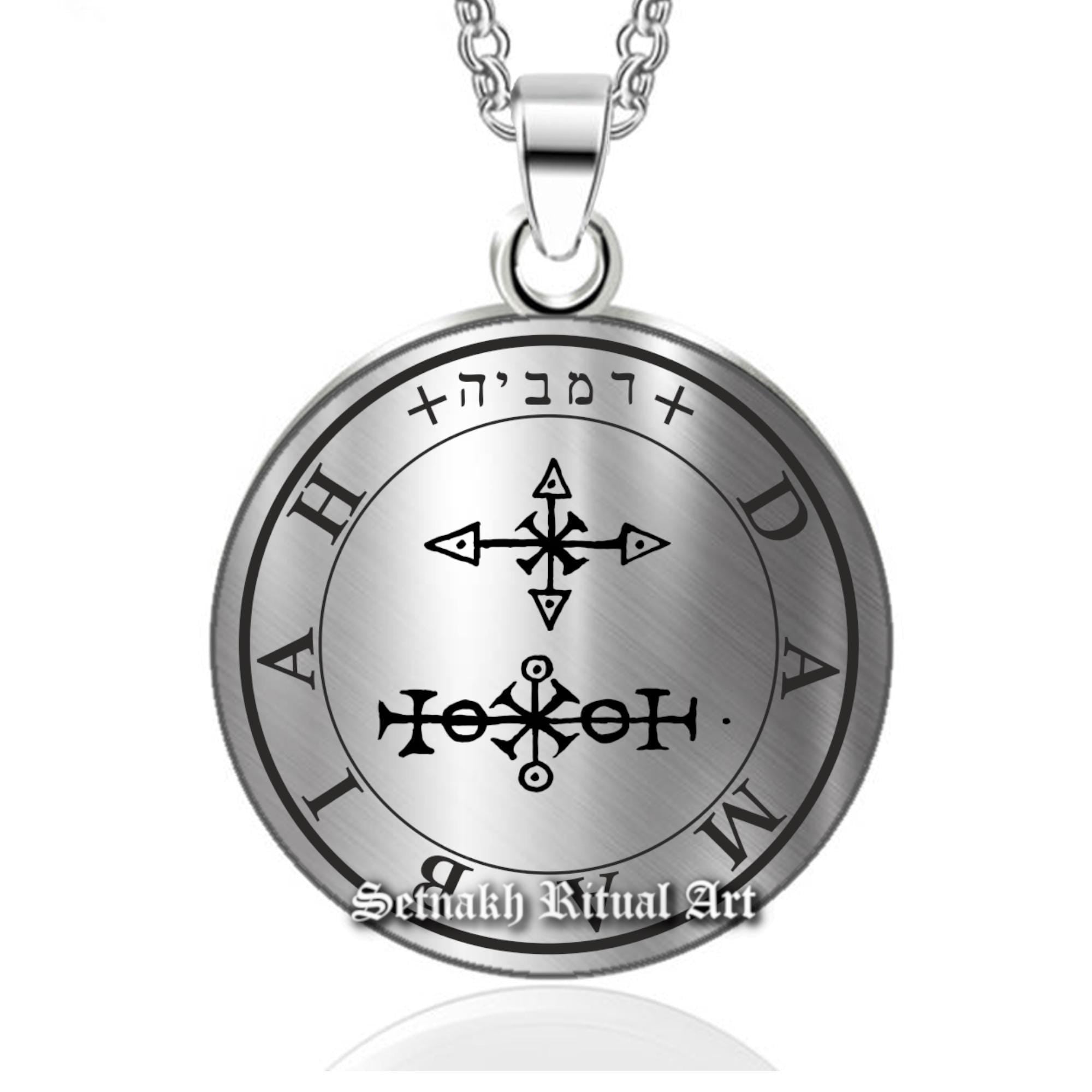 a silver necklace with an image of a compass on it